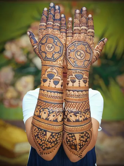An extremely detailed full-arm bridal design, featuring octagonal patterns with engagement rings and initials, perfect for a bride who wants maximum coverage.