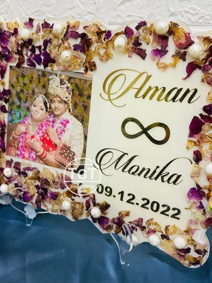 This frame shows a beautiful mix of preserved petals and pearls, creating a delicate and romantic keepsake for the couple.