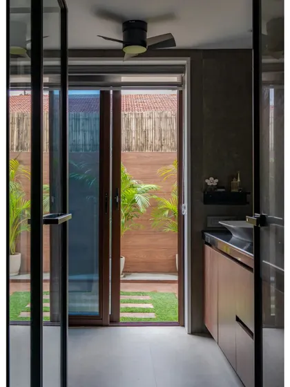 A view from the bathroom looking out into a small, private courtyard. This design choice ensures privacy while still allowing natural light and a view of the greenery to enhance the sense of tranquility.