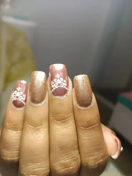 A close-up of the intricate white henna-style art I painted on these rose gold chrome nails. This kind of detail ensures your nails are a true work of art.