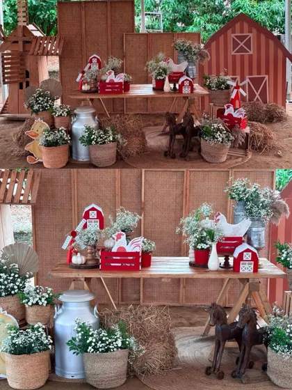A beautiful, rustic farm-themed dessert table setup, complete with a miniature barn, windmill, wooden horses, and hay bales, creating an authentic and charming atmosphere.