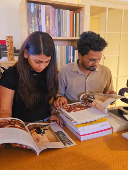 Our team members exploring the pages of a recent feature. We believe in continuous learning and drawing inspiration from our shared achievements.