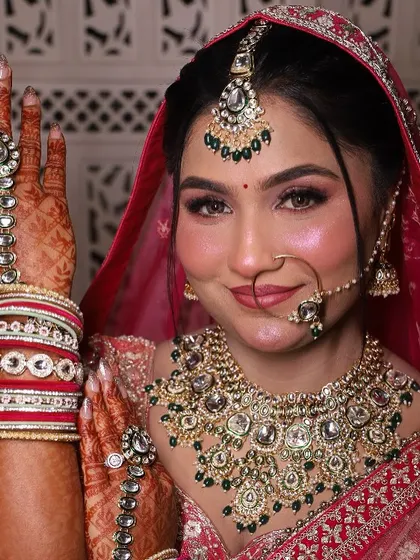 A classic bridal pose. This shot highlights the hand jewelry and the flawless makeup, from the defined eyes to the soft, radiant blush.