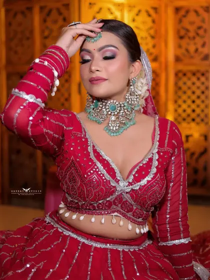 A serene portrait with the bride's eyes closed, as if making a wish. The focus is on her flawless makeup and the intricate details of her maang tikka.
