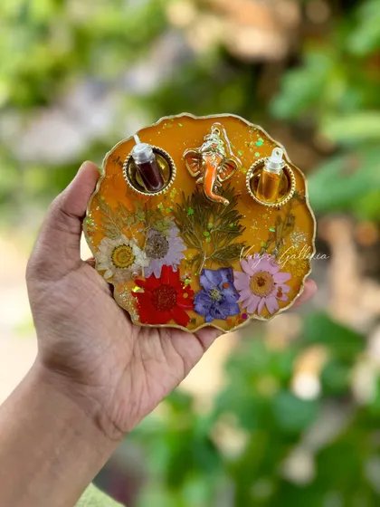 A vibrant yellow floral puja thali, handcrafted to bring a little glam to your rituals.