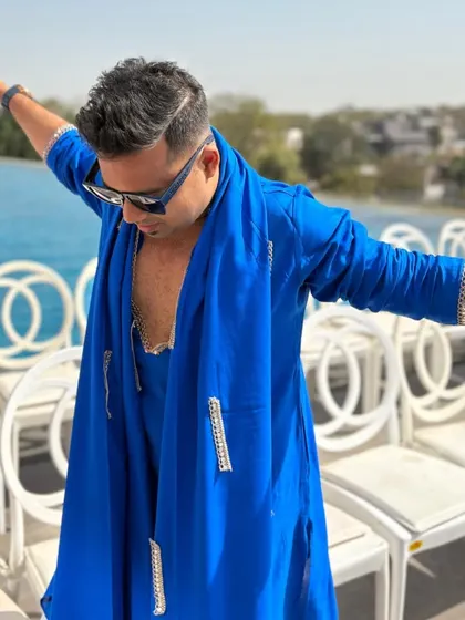 Feeling the shocking blue vibe by the pool, ready for a Haldi party. The open arms gesture is my invitation to everyone to join in the fun and let go.