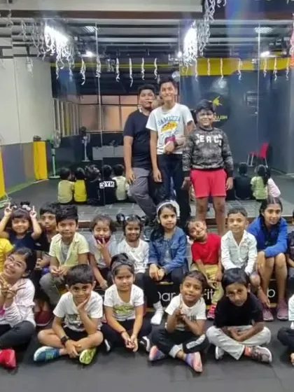 Another angle of our kids' batch posing in front of the studio mirror. The mirror is an essential tool for dancers to check their form and alignment.