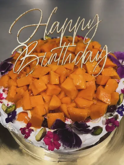 A twist on a classic! This is my signature Basque burnt cheesecake topped with fresh cream, organic Alphonso mangoes, and delicate edible flowers.