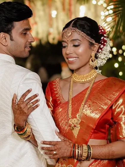 A beautiful moment between the bride and groom. The elegance of the saree drape adds to the romance of the picture.