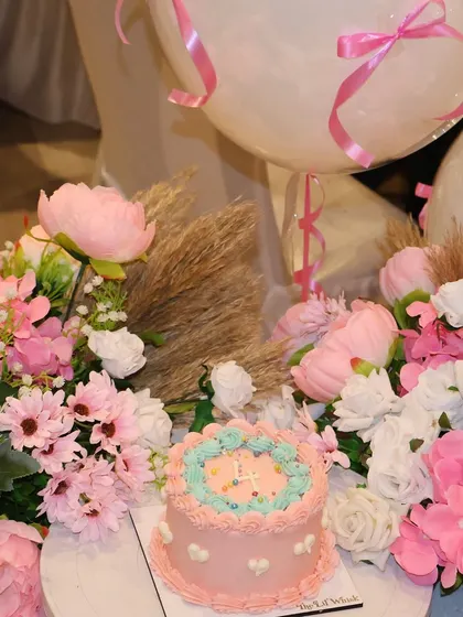 The beautiful anniversary cake we celebrated with, surrounded by a gorgeous pink floral arrangement.