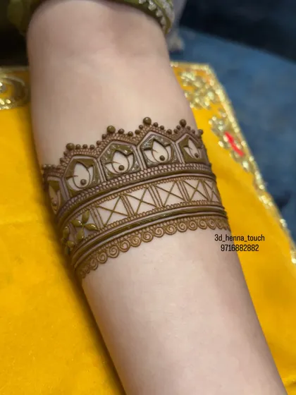 The lotus arm band with a geometric pattern added below. The contrast between the soft floral shapes and the sharp geometric lines is visually striking.