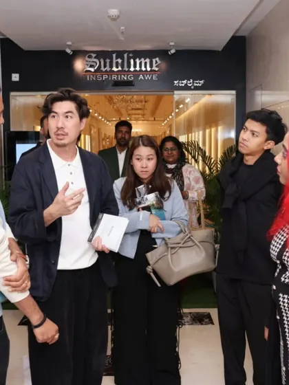 Guests interacting with our team at the entrance of the 'Ethereal Charm' exhibition.