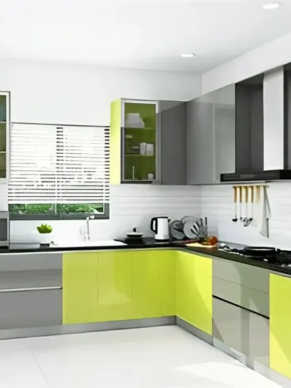An L-shaped kitchen that uses a vibrant lime green on the lower cabinets to add a pop of color. The glossy grey upper cabinets and black countertop create a sleek and contemporary feel.