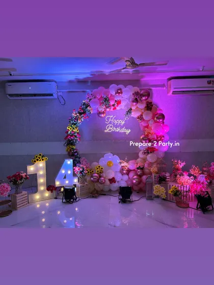 These images showcase the details of the floral 14th birthday, including the light-up numbers and the mix of balloons and flowers that create a fun yet sophisticated look for a teenager.