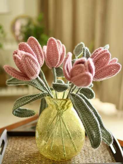 The dusty pink tulips look just as lovely in this yellow glass vase, which makes their colour pop.