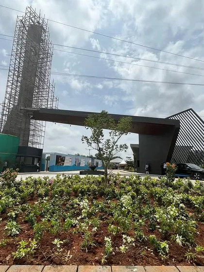 The entrance gate and a landmark tower for a new development taking shape, showcasing the project's ambitious scale even during the construction phase.