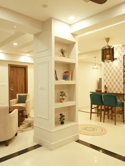 I love turning structural challenges into design features. Here, a central column was transformed into a beautiful display bookshelf, seamlessly integrating it into the open-plan living and bar area.