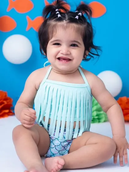 A beautiful, big smile from our little mermaid. Even with all the cake and excitement, I make sure to capture those moments where they look right at the camera and flash their winning smile.