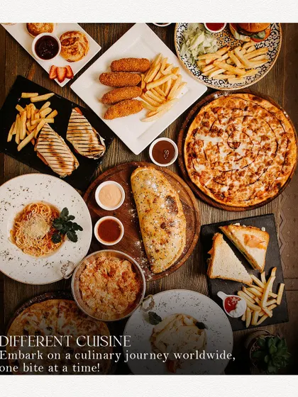 An overhead shot of a massive food spread, from pizza and pasta to fries and sandwiches. This image announces the World Food Carnival, a place to embark on a culinary journey.