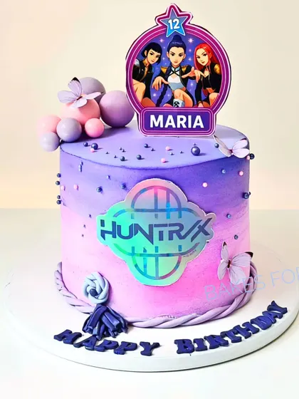 For the K-Pop fans, this Huntrix: K-Pop Demon Hunters cake features a vibrant purple and pink ombre design with a holographic logo. It's a trendy and exciting cake for a tween's birthday celebration.