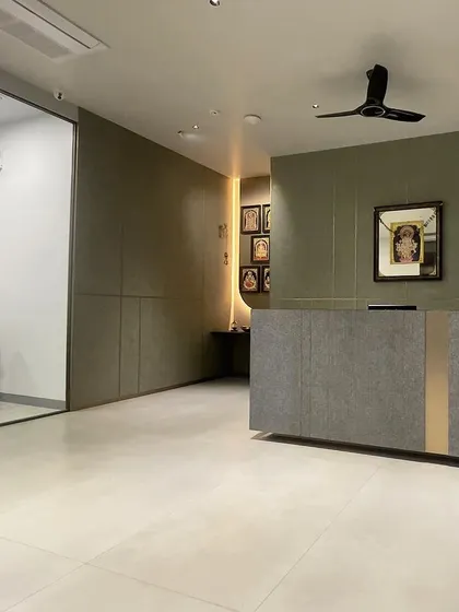 The reception area at VEE CEE EXPORTS, with a minimalist desk and subtle, warm lighting. The design is clean, professional, and welcoming.