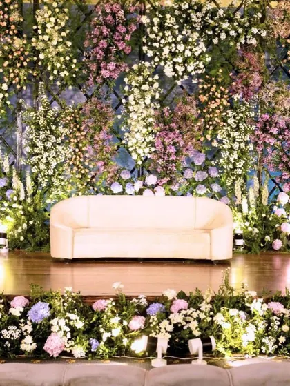 For this reception, we created a breathtaking backdrop with a wall of lavender and pastel florals. The strategic arrangement of hydrangeas, roses, and baby's breath created a magical and enchanting photo wall.