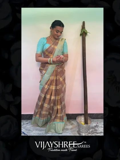 Reethu Baratam celebrating a traditional ceremony in a checked Kanjivaram with a beautiful aqua blue border.