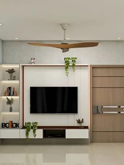 This TV unit design includes a white floating console with integrated backlighting and vertical shelves. The simple and clean layout is perfect for keeping the living room organized and stylish.