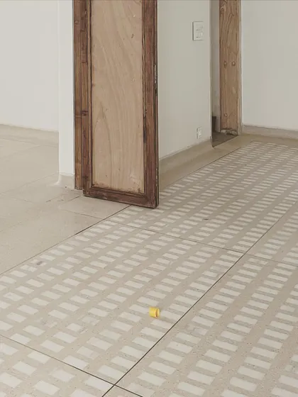 The finished custom terrazzo floor, with its clean, geometric pattern, brings a timeless and handcrafted quality to the space. The single yellow piece is a small, intentional imperfection.