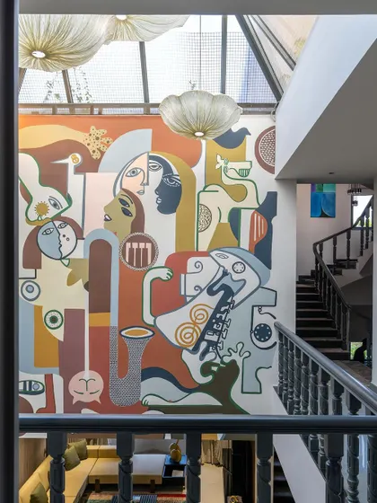 This angle captures the full height of the mural, emphasizing how it transforms the main living area into a gallery-like space.
