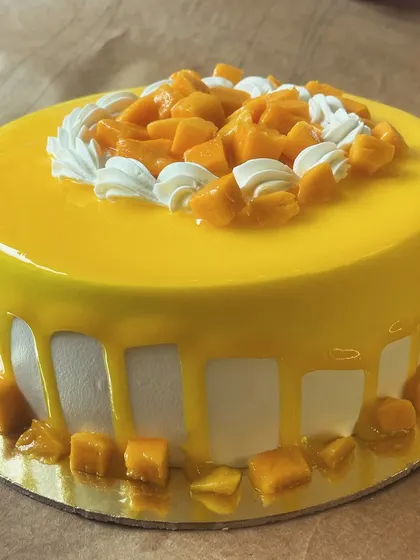 Our irresistible Mango Cake is back for the season. This one features a glossy mango glaze drip and is topped with fresh mango chunks.