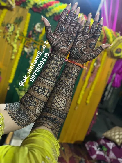 A beautiful shot of a bride's full mehndi against a vibrant yellow backdrop from her haldi or mehndi ceremony.
