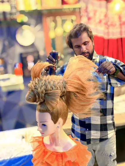 Another angle of me working on the fish hairstyle, demonstrating the hands-on approach I take to teaching even the most complex designs.