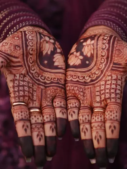 A full view of the stained palms, showcasing the intricate floral and geometric patterns in a deep, beautiful color.