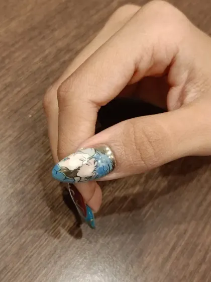 A detailed shot of the thumb nail from the "Howl's Moving Castle" set, showcasing the intricate, abstract blue and white pattern.