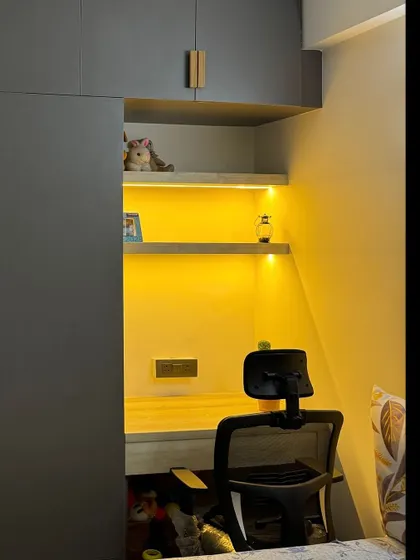 A closer look at the integrated study nook within the wardrobe. The warm backlighting makes it a comfortable space to work or study.