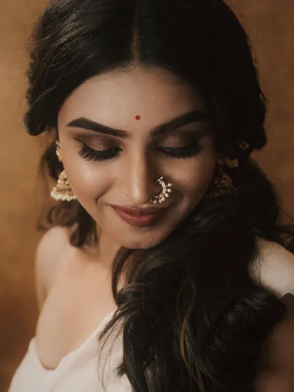 The same look, capturing a soft, happy expression. The makeup is designed to be versatile, looking just as beautiful in candid moments as it does in posed portraits.