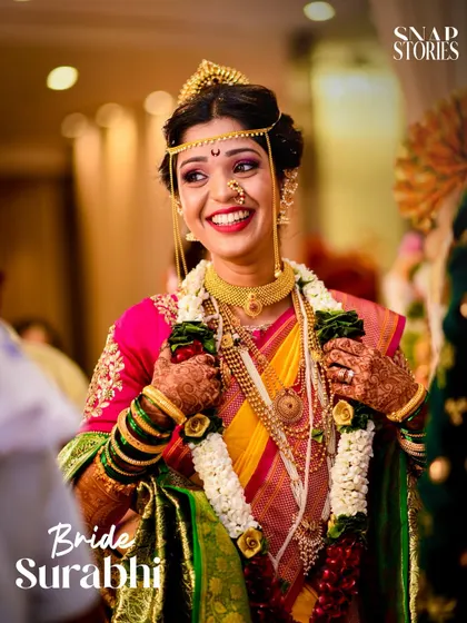 A stunning portrait of the bride, showcasing her traditional Maharashtrian bridal jewelry and joyful expression. We excel at capturing beautiful bridal portraits.