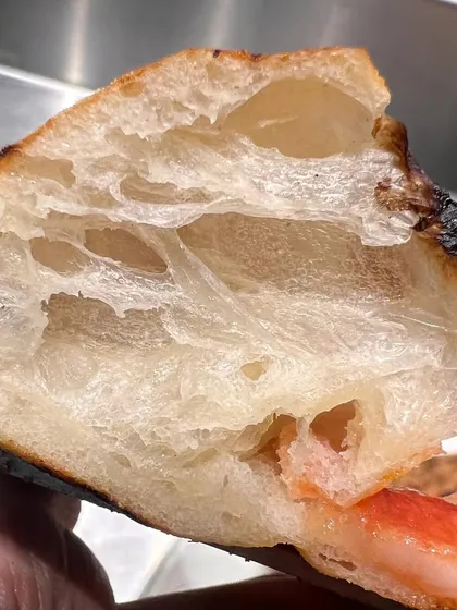 Another beautiful cross-section of our dough. This airy texture is the result of slow fermentation and high-heat cooking.