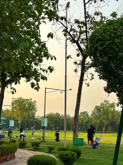 The tranquil atmosphere of the range at dusk, as players continue their practice.