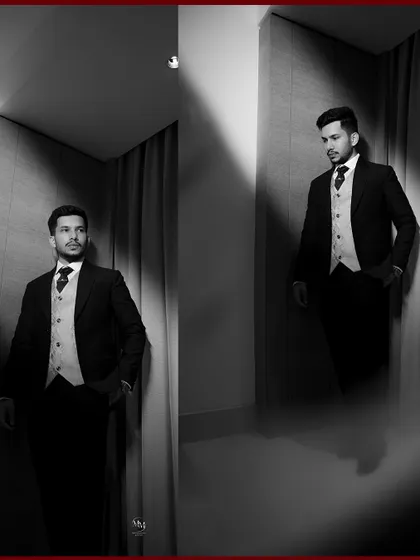 A dramatic black and white groom's portrait using shadows and reflections to create a powerful and stylish image.