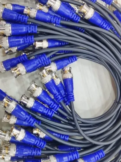 A bundle of grey cables with blue BNC connectors.