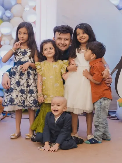 A heartwarming photo of the little one with his friends and family after his Mundan ceremony.