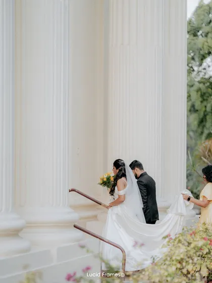 The couple descending the church steps, a classic and elegant wedding day photograph.