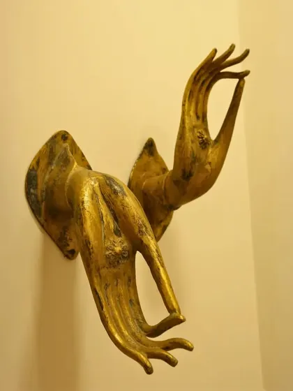 These golden, sculpted hands in a mudra (a symbolic gesture) serve as unique wall decor. They bring a sense of peace and mindfulness, turning a simple wall into a statement of spiritual elegance.