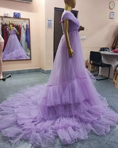 A side view of the lavender tiered tulle gown, showing the length of its beautiful train. The layers of fabric create wonderful movement and volume.