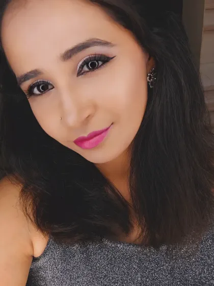 A selfie showing a fun party look. This features a sharp winged liner, shimmery silver eyeshadow, and a bright fuchsia pink lip for a modern and trendy vibe.