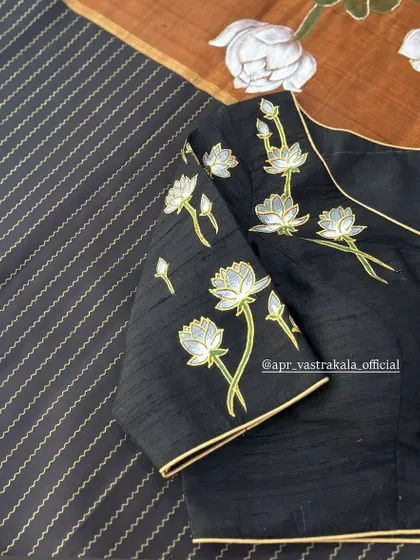 A full view of the elegant black blouse with painted lotuses.