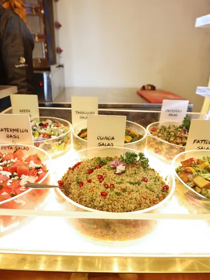 A vibrant salad bar featuring a variety of options, including watermelon and feta salad, quinoa salad, and fattoush. Our salads are always fresh, colourful, and full of flavour.