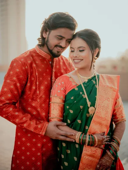 An intimate moment between the couple, with the bride's glowing makeup and traditional attire taking center stage.
